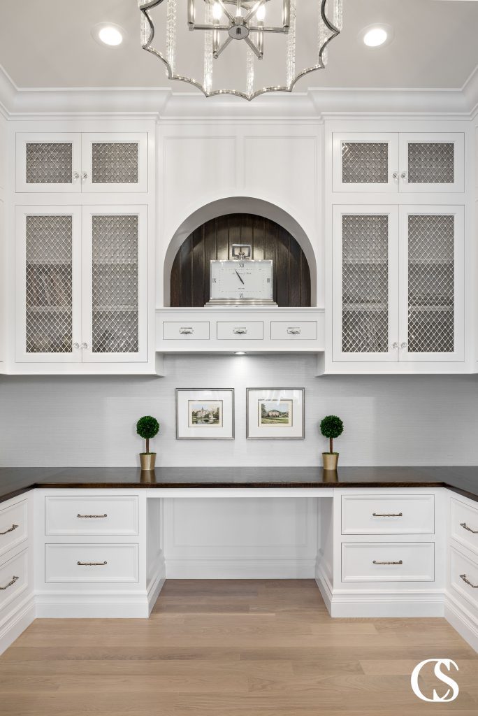 The mullions on the glass doors of these custom office cabinets add so much eye candy to this work from home space.