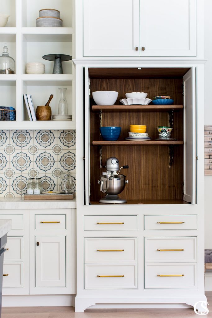This unique kitchen cabinet design conjures memories of a vintage kitchen while offering complementary modern elements to balance out the look. Dare you not to dream of that custom tile backsplash!